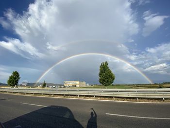 Scenic view of rainbow over city against sky