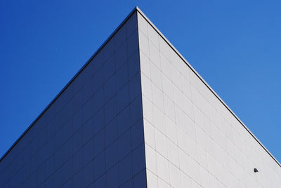 Low angle view of modern building against clear blue sky