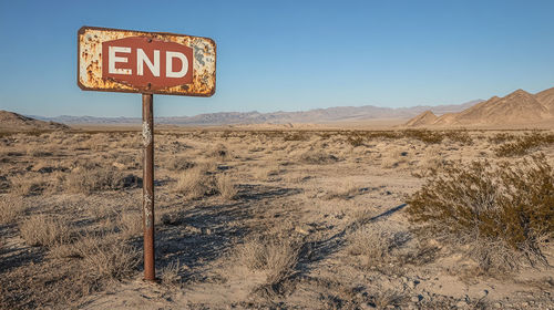 Information sign on landscape against clear sky