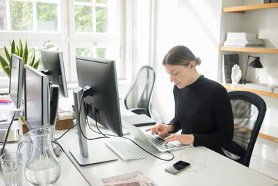 Midsection of a woman working n desk