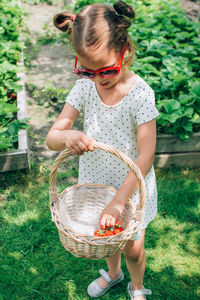 Full length of cute girl holding basket