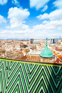 Aerial view of buildings in city against sky