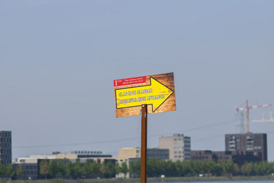 Information sign in city against clear sky