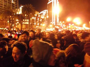 People walking on street in city at night