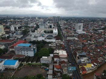 High angle view of buildings in city against sky