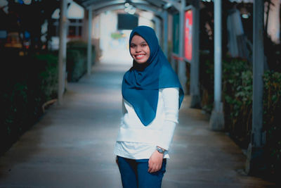 Portrait of young woman standing outdoors