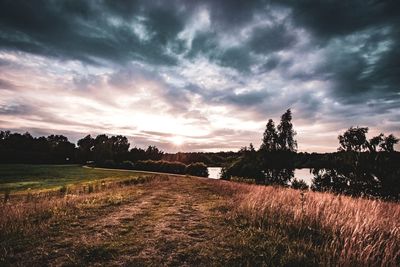 Scenic view of field against sky during sunset