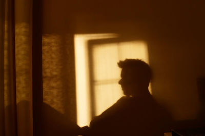 Silhouette of man in window