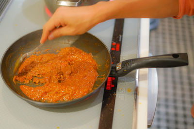 Cropped hand preparing food