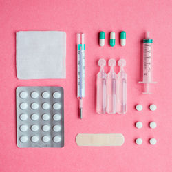 Still life of medical supplies on pink background