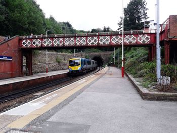 Train at railroad station against sky