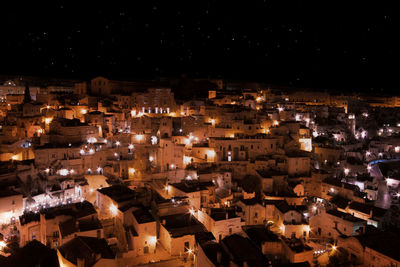 High angle view of illuminated buildings in city at night