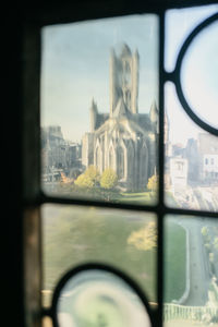 Close-up of city seen through window of building