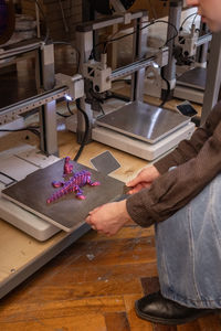 Midsection of man working in workshop