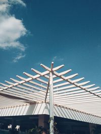 Low angle view of windmill against blue sky