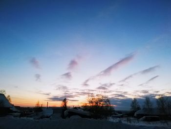 Scenic view of landscape against blue sky during sunset