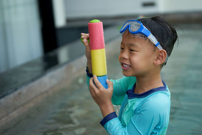 Cute boy holding toy outdoors