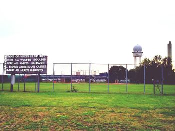 Information sign on field against clear sky