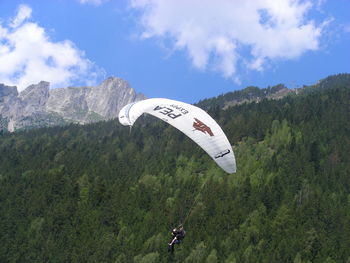 Low angle view of man on mountain against sky