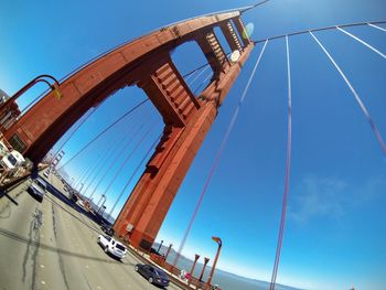 Low angle view of bridge against blue sky