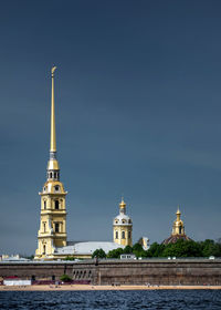 Peter and paul cathedral by river against blue sky