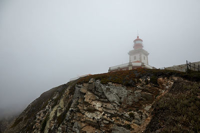 Lighthouse at cape cabo da roca near city of cascais, portugal points way for ships during storms