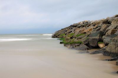 View of calm beach against the sky