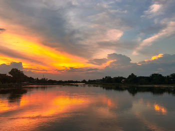 Scenic view of lake against orange sky