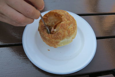 High angle view of person holding bread in plate