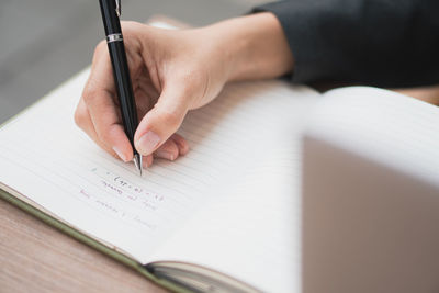 Cropped hand writing in book