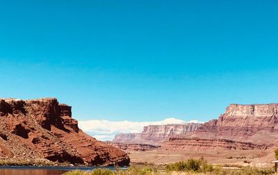 Scenic view of mountains against clear blue sky