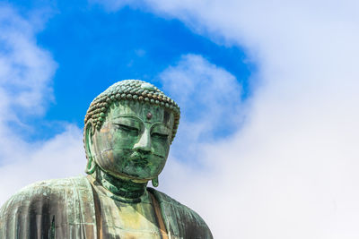 Low angle view of statue against sky