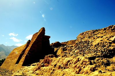 Low angle view of rock formation against sky