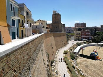 High angle view of people in historic building against sky