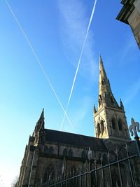 Low angle view of vapor trail against blue sky