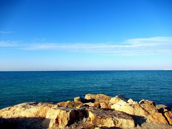 Scenic view of sea against blue sky