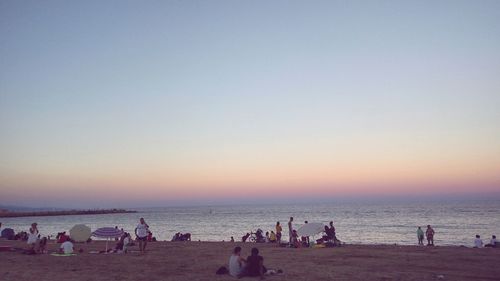 People on beach at sunset