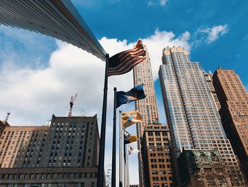 Low angle view of buildings against cloudy sky