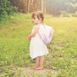 Girl standing on grassy field