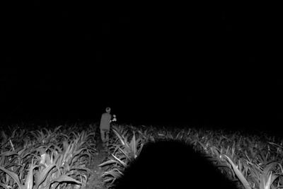 People standing on field at night