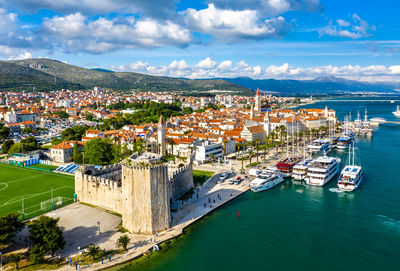 High angle view of townscape and sea against sky