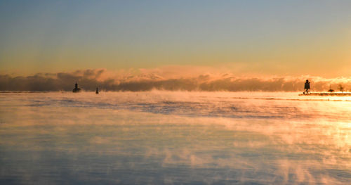 Sunrise along the frozen winter lake in the city