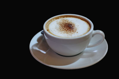 High angle view of coffee cup against black background