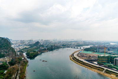 High angle view of river amidst buildings in city