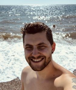 Portrait of smiling young man on beach