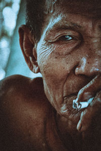 Close-up portrait of shirtless man