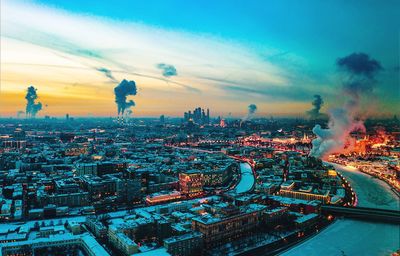 High angle view of illuminated city buildings against sky