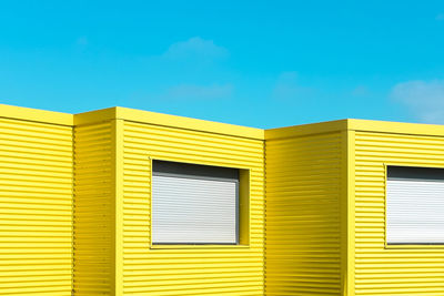 Yellow buildings against clear blue sky