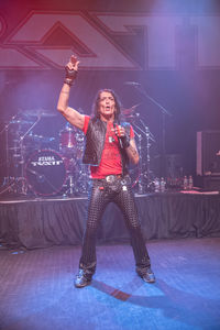 Portrait of smiling woman standing on stage