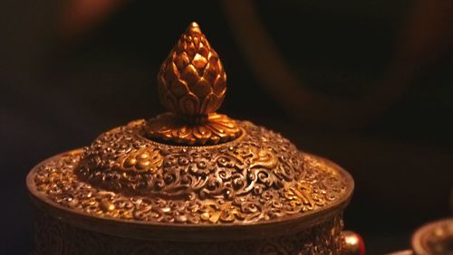 Close-up of illuminated lamp on table